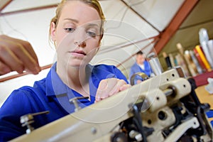 Woman threading sewing machine