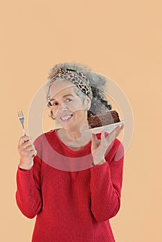 Woman with thrilled expression holding chocolate cake