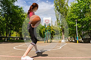 Woman Throwing Basketball from Top of Court Key