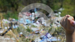 Woman throwing disposable cap into open dumping in the middle of forest, ecology