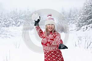 Woman throwing a large snowball