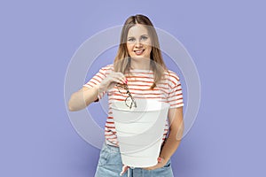 Woman throwing out optical glasses after laser vision treatment being happy to have better eyesight