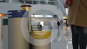 Woman throwing out plastic bottle into recycable