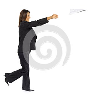 Woman throwing paper plane