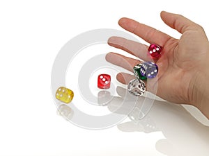 Woman throwing some colorful dices with her hands isolated on white background. Gambling, casino and business concept