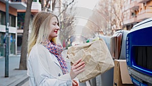 Woman throwing and sorting an paper trash in recycling garbage container bin