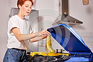 Woman throws banana peel in the trash sorting waste, Zero Waste Concept.