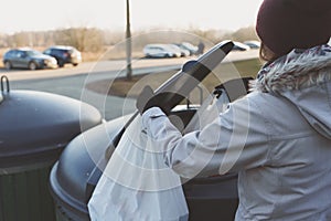 Woman throws garbage