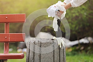 Woman throws plastic garbage in the trash. woman hand picking up garbage plastic for cleaning at park. garbage collection after a