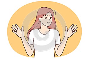 Woman throws up hands, denying involvement in problem or demonstrating ignorance of answers photo