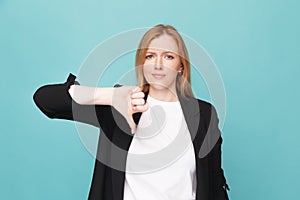 Woman thumb down isolated over the blue background.