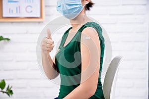 woman thumbs up after get vaccinated