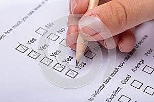 Woman Ticking Yes Choice On Review Form