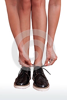 Woman tie shoelaces on brogue shoes