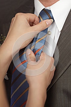 Woman ties man to tie