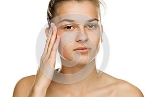 Woman tightening  her face skin with the fingers