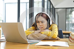 Woman tired and bored from working or learning online.