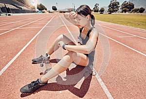 Woman, tired and checking smart watch on running track in fitness, workout or exercise training for speed, pace or