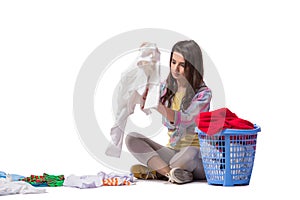 The woman tired after doing laundry isolated on white