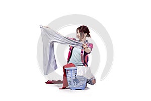 The woman tired after doing laundry isolated on white