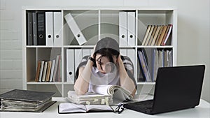 Woman tired of paperwork in the office