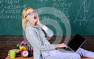 Woman tired teacher work laptop classroom chalkboard background. Working conditions which prospective teachers must