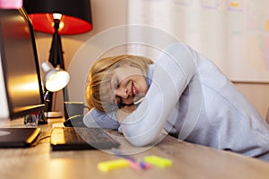 Woman tired while working in an office sleeping at her desk