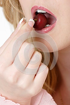 Woman about to eat a cherry