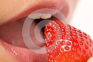 Woman about to eat a strawberry