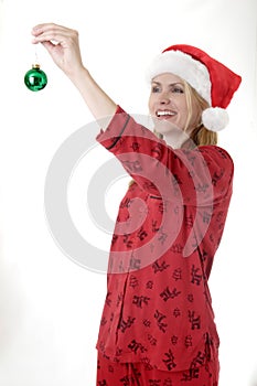 Woman about to hang a Christmas ornament