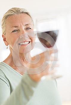 Woman Toasting Wineglass At Home