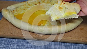 Woman took piece of khachapuri cheese pastry, took bite and put it back