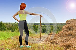 Woman with a tool for harvesting a bevelled row photo