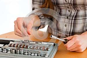 Woman with toolbox and screwdriver