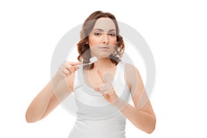 Woman with toothbrush isolated on white