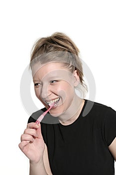 Woman with toothbrush smiling