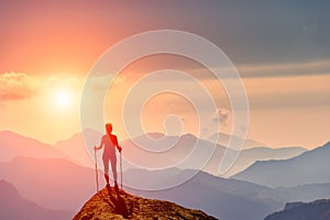 Woman at the top of a mountain