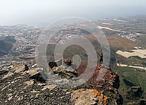 Woman on a top of a mountain enjoying valley view