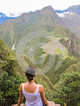 Woman at the top of Wayna Picchu mountain in Machu Picchu