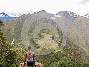 Woman at the top of Wayna Picchu mountain in Machu Picchu