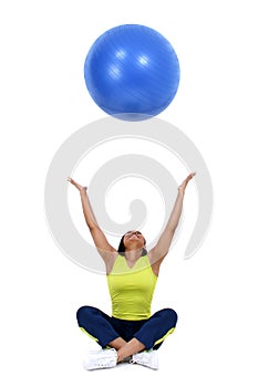 Woman tossing blue ball