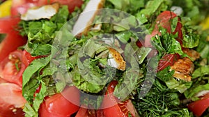 Woman tossing green salad