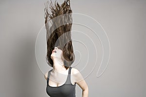 Woman Tossing Long Brown Wavy Hair