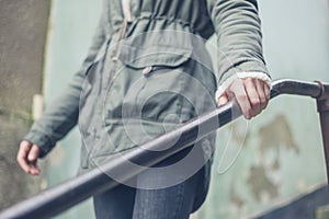 Woman touching banister outside