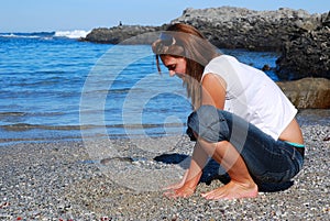 Woman touching beach sand