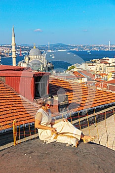 Woman touching the cat at the roof of Bosphorus in Istanbul