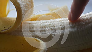 Woman touching with a finger of purified banana, macro close up view