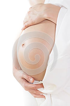 Woman touching her belly over white background