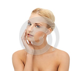 Woman touching her face skin