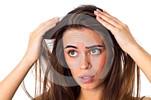 Woman touching her hair roots